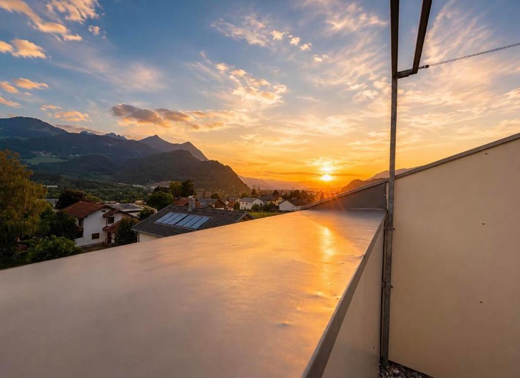 a view of the sunset from the balcony of a house at Bergzauber in Bludenz