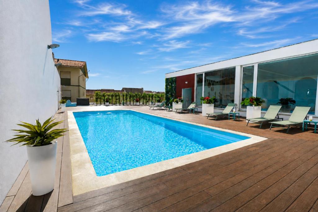 a swimming pool on top of a building at Spirit Hotel Fonte Real in Monte Real
