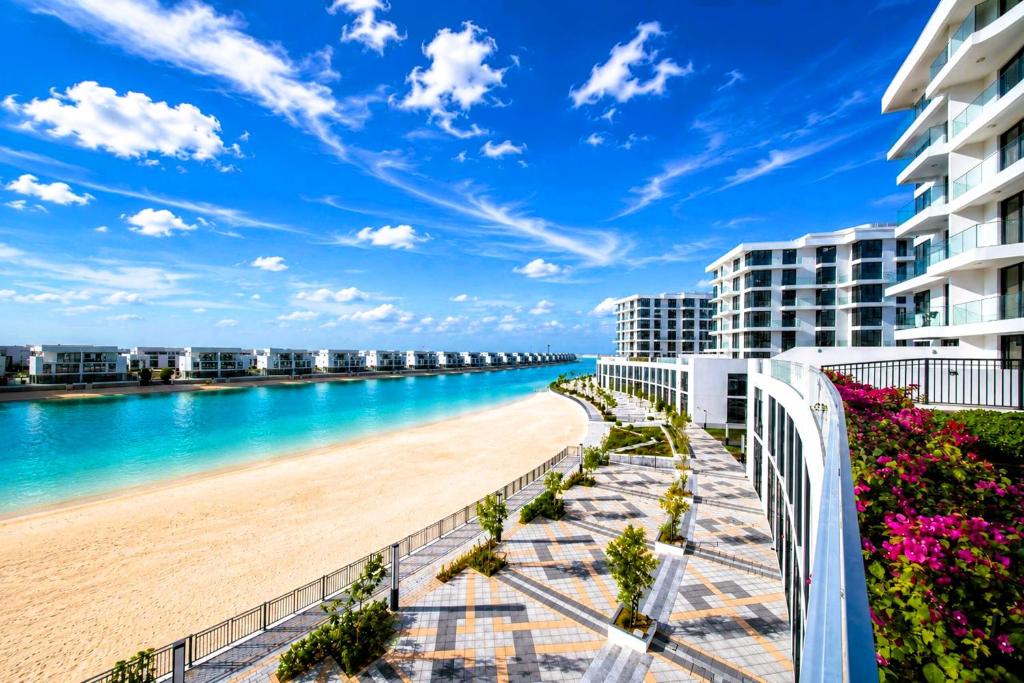 a view of the beach from the balcony of a resort at Luxury Sea Living in Sharjah