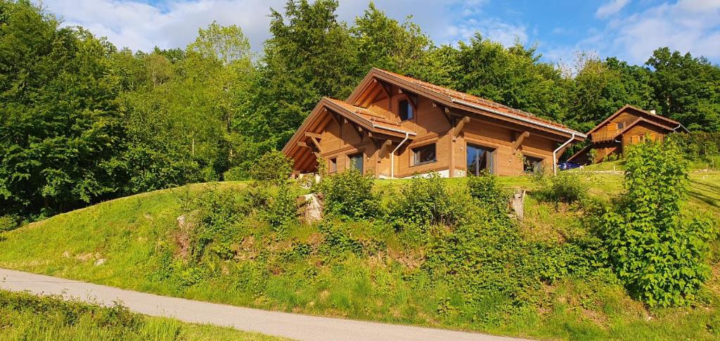 a house sitting on top of a hill at Le BÔ Chalet - Jacuzzi et Sauna - 3 chambres in Anould