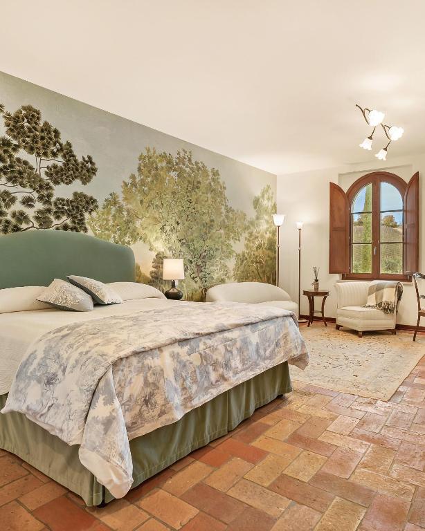 a bedroom with a large bed and a couch at Tolaini Winery Suites in Castelnuovo Berardenga