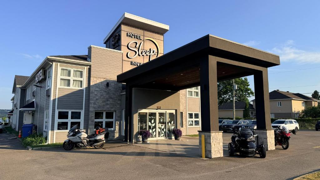 a shop with motorcycles parked in front of it at Sleep Inn & Suites Quebec City East in Boischâtel