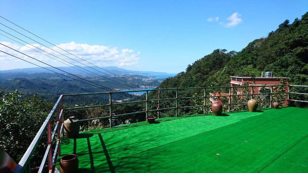 a balcony with a view of a mountain at Way Young House in Jiufen