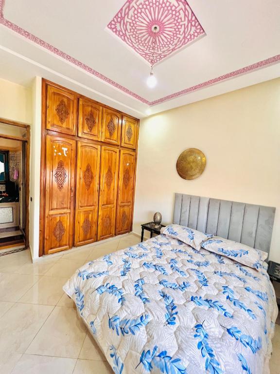 a bedroom with a bed and a ceiling at Mhamid 4 in Marrakesh