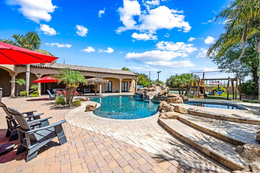 a swimming pool in a resort with a picnic table and chairs at 104th Mesa 1331 Paradise Found in Mesa