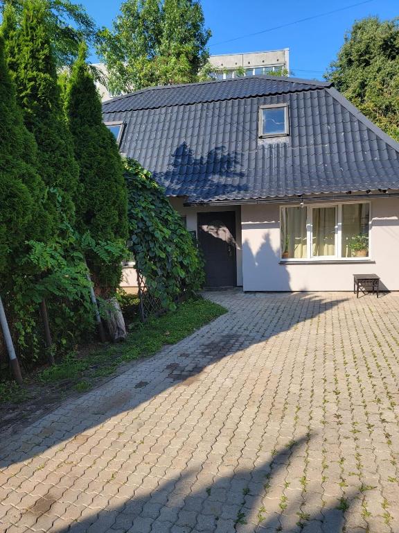 a house with a brick driveway in front of it at The Loka in Riga
