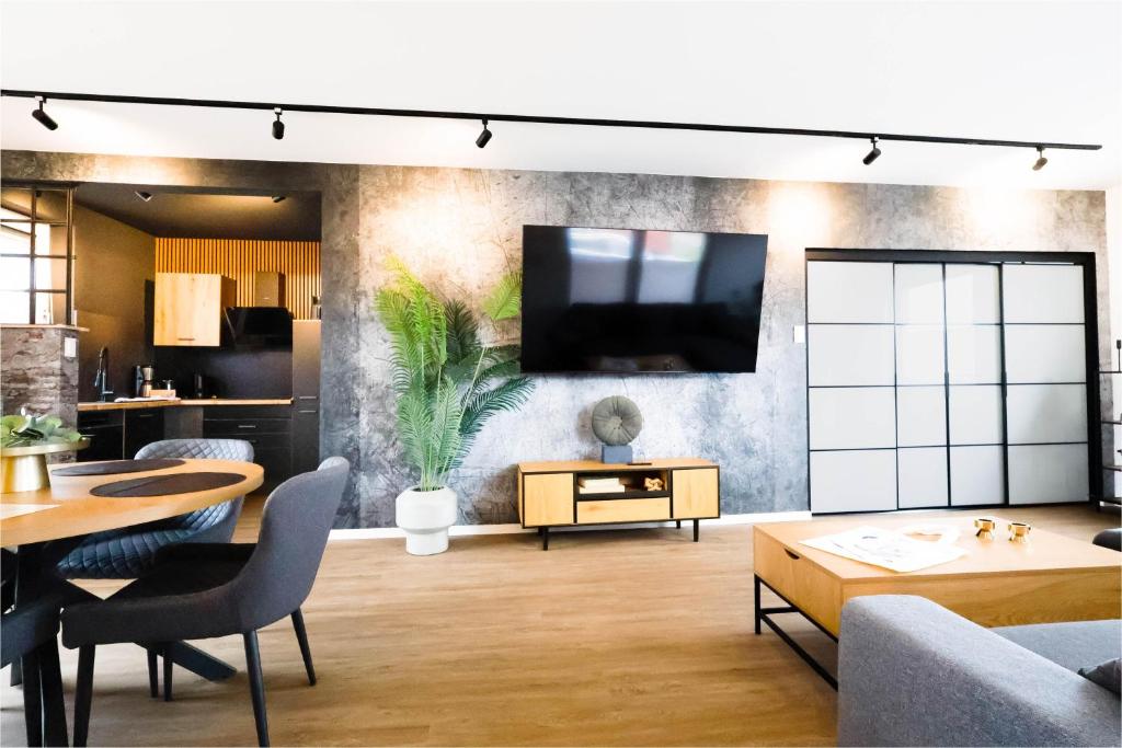 a living room with a tv on a wall at Kleine Austernperle in Dornumersiel