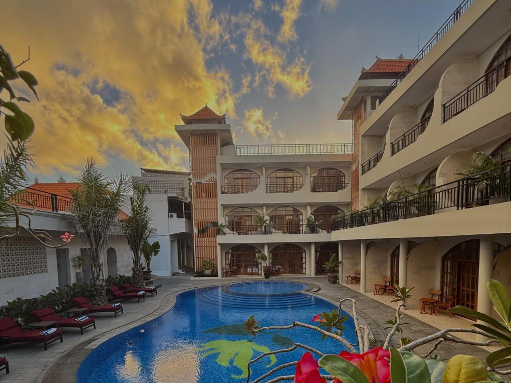 a large swimming pool in the middle of a building at Sandat Mas Uluwatu in Uluwatu