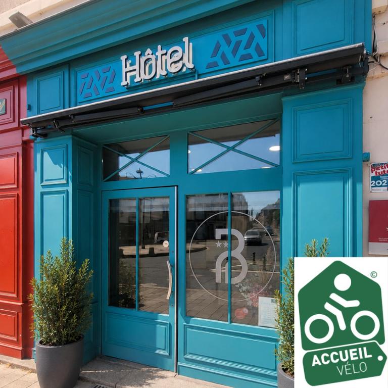 a blue building with a hotel sign on it at Hôtel Le petit billot in Vitré