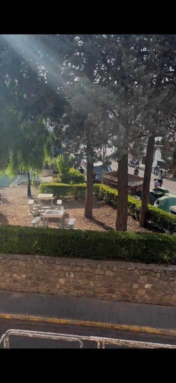 a park with picnic tables and trees in a city at Argentina 32 in Ayora