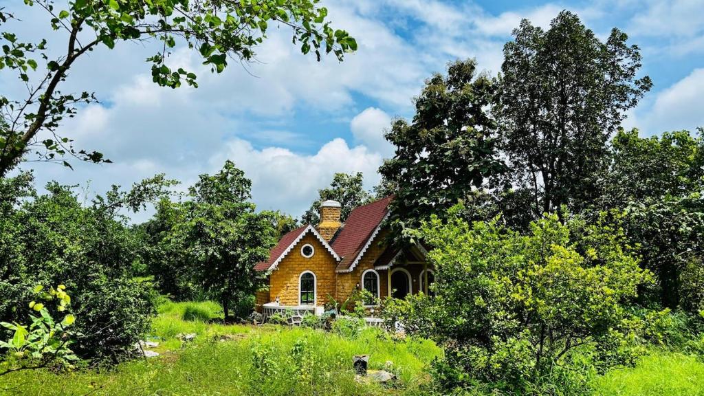 a small church in the middle of a field at StoneHaven 1BHK pvt Pool in Agashi