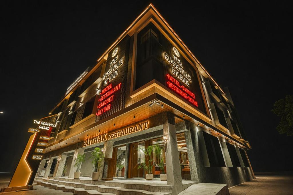 a building with signs on it at night at The Roseville Grand Near Chandigarh University-Rayat Bahra University Kharar Chandigarh in Kharar