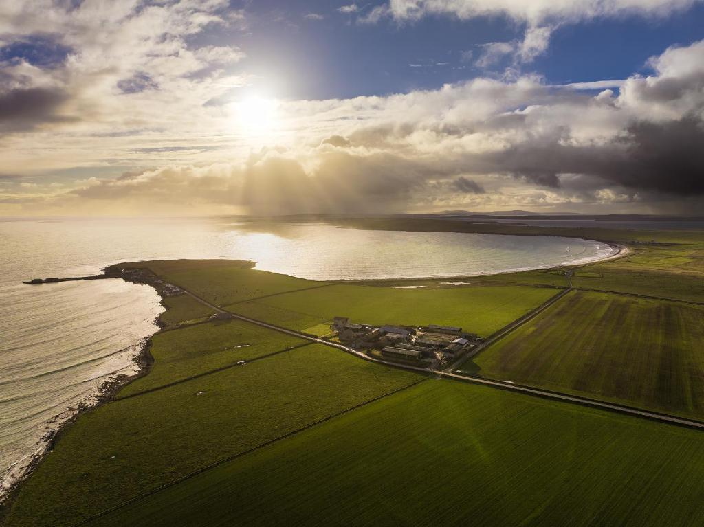 an aerial view of the shoreline of the ocean at Orkney Retreats Island Farmhouses & Cottages in Sanday