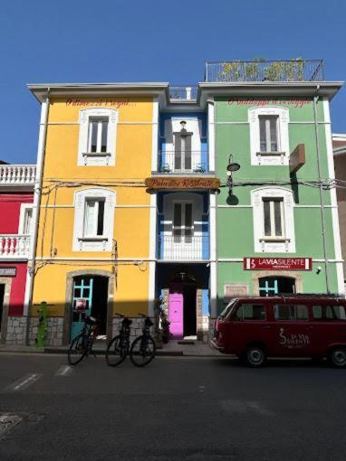 a red van parked in front of a colorful building at Palazzo ReSilente- B&B dell'Infopoint in Castelnuovo Cilento