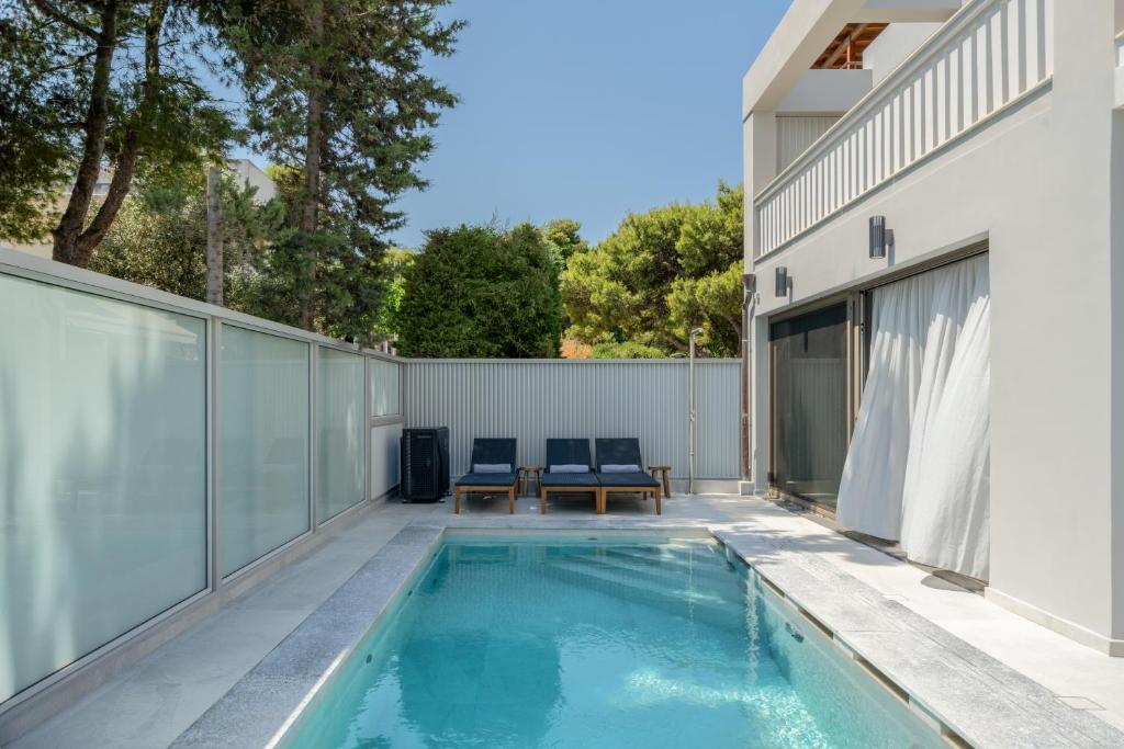 a swimming pool in the backyard of a house at Villa Occasus by A&D Properties in Porto Rafti