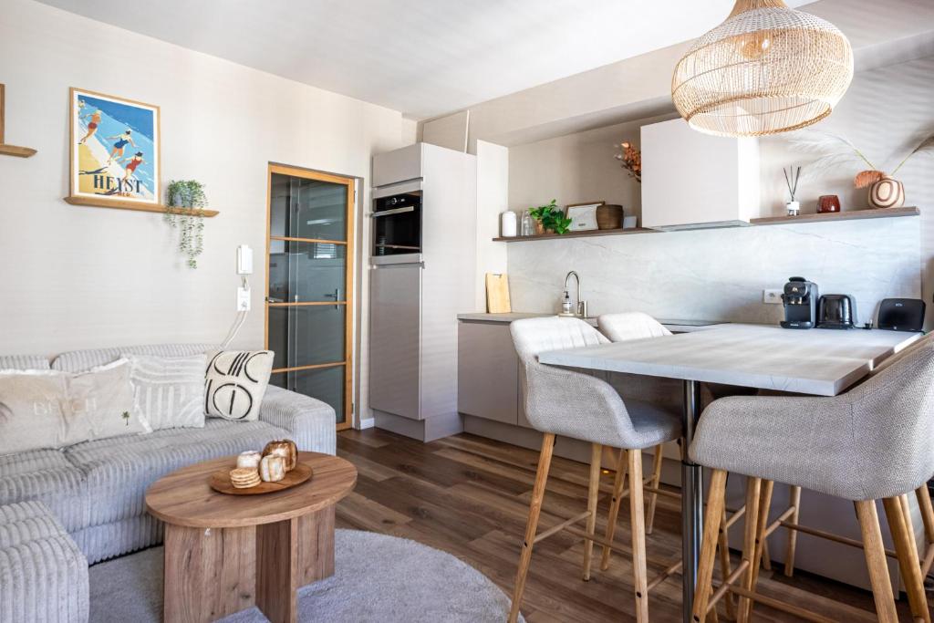 a kitchen and living room with a couch and a table at Luxury Apartment Knokke-Heist in Knokke-Heist