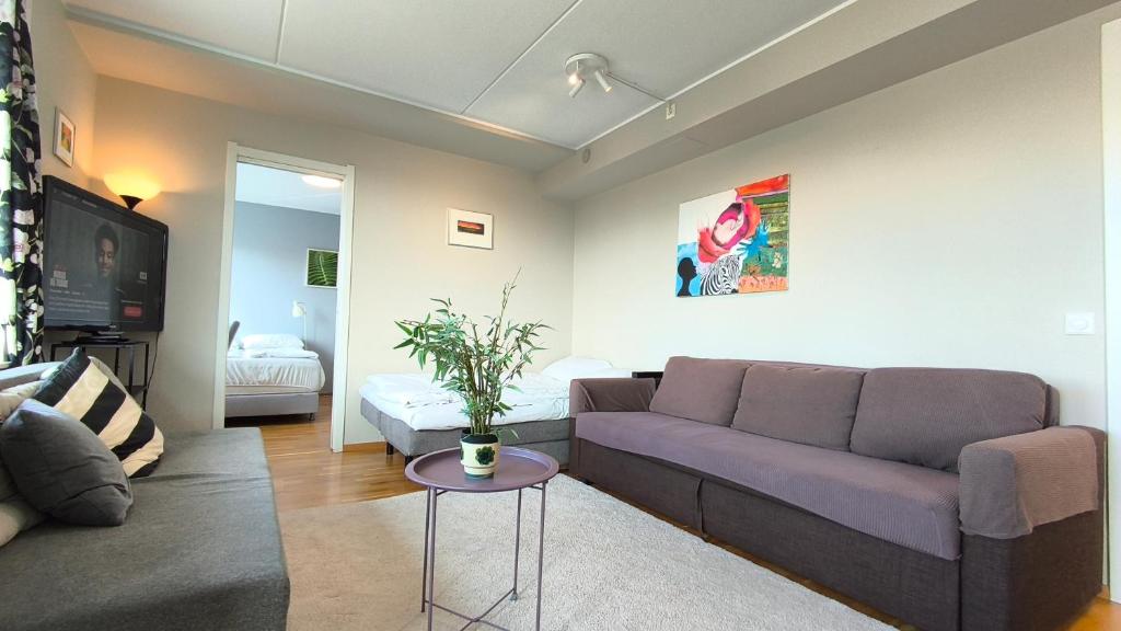 a living room with a couch and a table at Møllergata apartment in Oslo