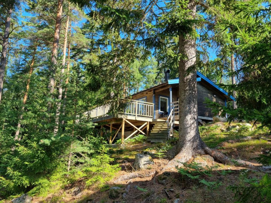 a log cabin in the woods with trees at Forest Lodge Ryokan in Trosa