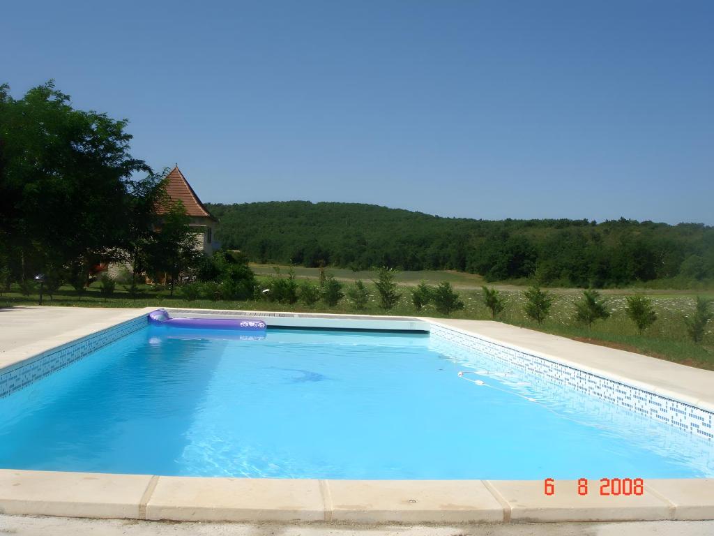 a large swimming pool with blue water at Bergerie - piscine privée in Cadrieu