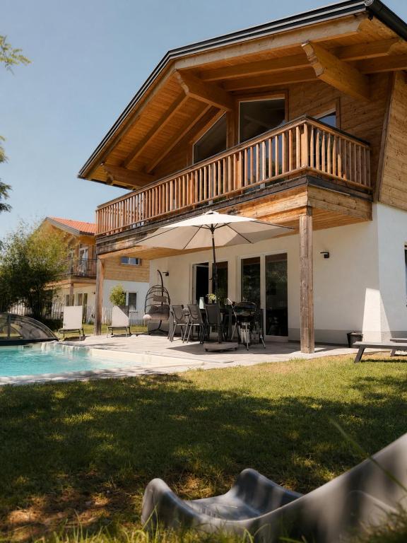 a house with a deck and a pool at Luxalps- BergZeit- Inzell- Sommerpool- Sauna- Wandern- Chiemgau Card in Inzell