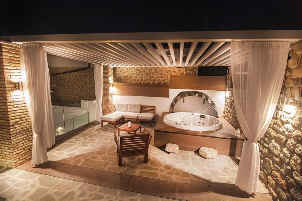 a large bathroom with a tub and a sink at Lithos House & Spa in Nafpaktos