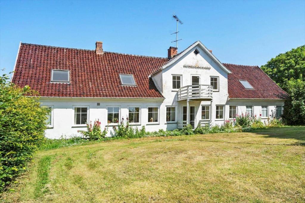 a large white house with a red roof at 6048-Stege-Kostervej-48 in Stege