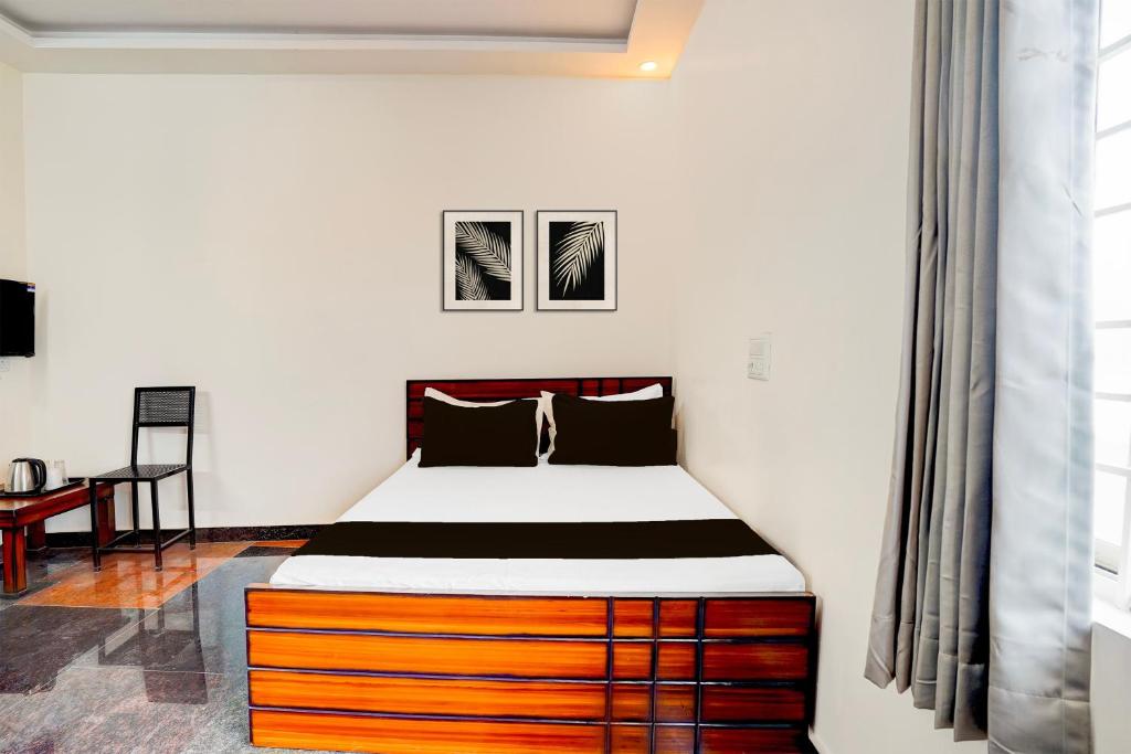 a bedroom with a bed with a wooden drawer at SPOT ON Sj Comforts Boarding And Lodging in Jigani