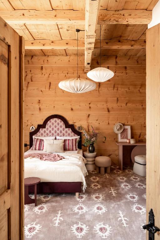a bedroom with a bed and a wooden wall at Owca na Polanie in Zakopane