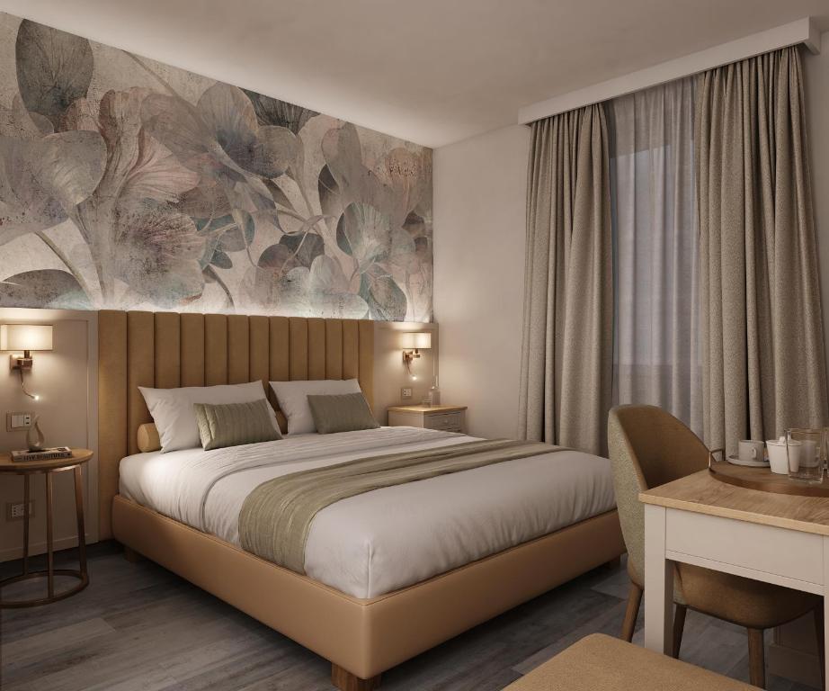 a bedroom with a bed and a painting on the wall at PFA Hotel - Viareggio in Viareggio