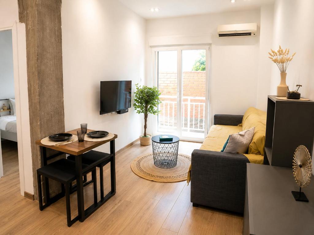 a living room with a couch and a table at Lyda Apartment in Alexandroupoli