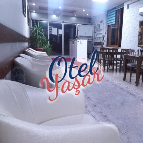 a group of white couches in a room at Yaşar otel in Mersin