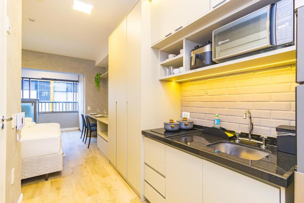 a kitchen with a sink and a counter at Prime Exalt Ibirapuera in São Paulo
