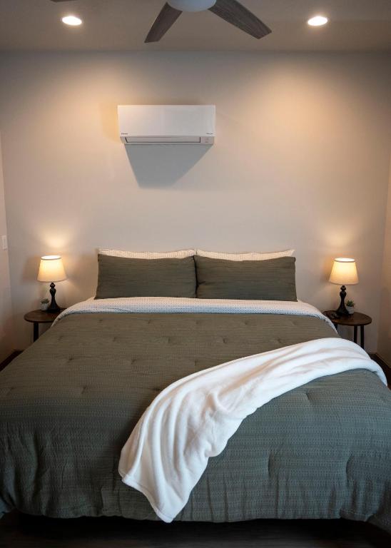 a bedroom with a bed with two lamps on both sides at The Sand and Sage Suite in Page