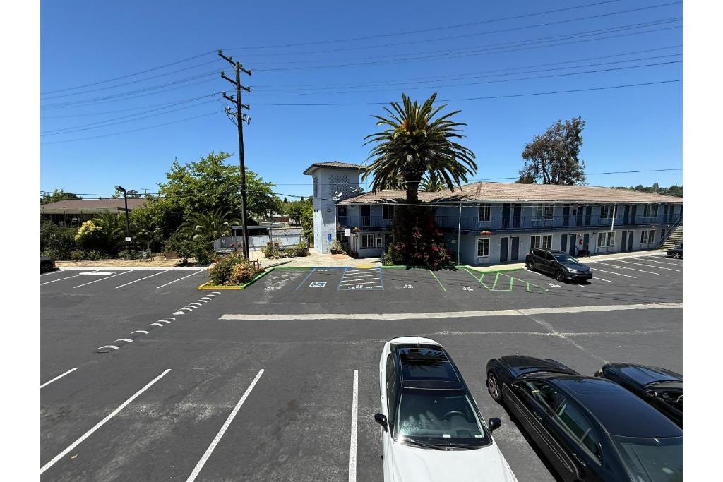 a parking lot with cars parked in front of a building at Solano Inn Vallejo Napa Valley - Six Flags in Vallejo