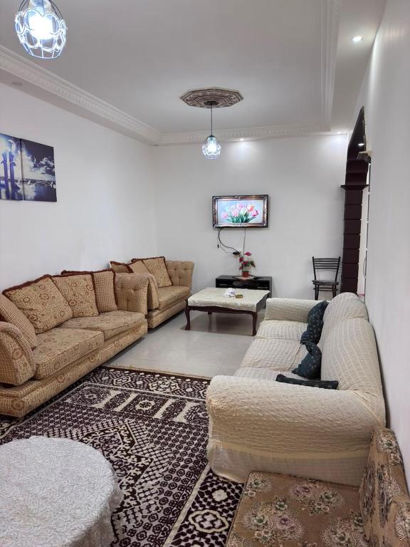 a living room with two couches and a tv at شقه مفروشة الجبيهه in Amman