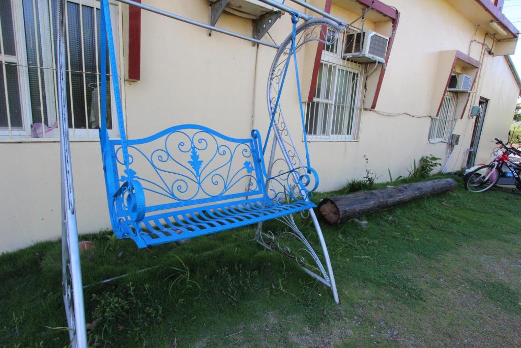 a blue chair sitting in front of a house at Wu Li Ting B&B in Hengchun