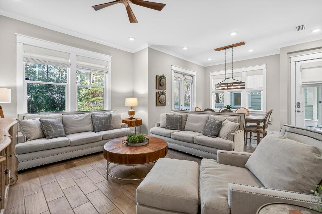 a living room with couches and a table at Mystic Seas in Watersound Beach