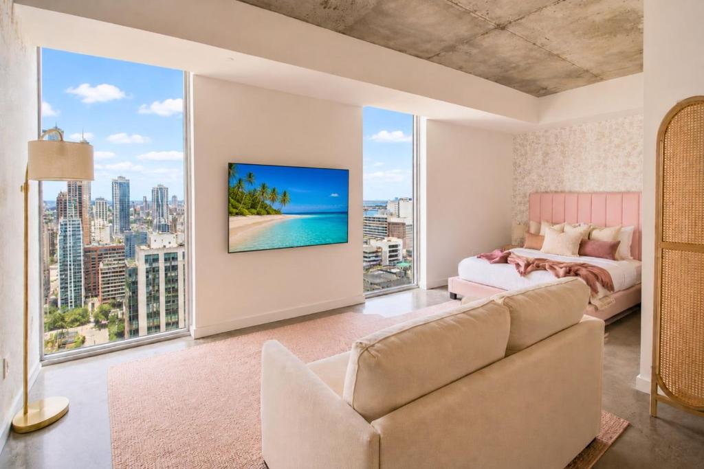 a bedroom with a couch and a bed and a large window at CD1608 Downtown Loft with Pool a Gym and City Views in Miami in Miami