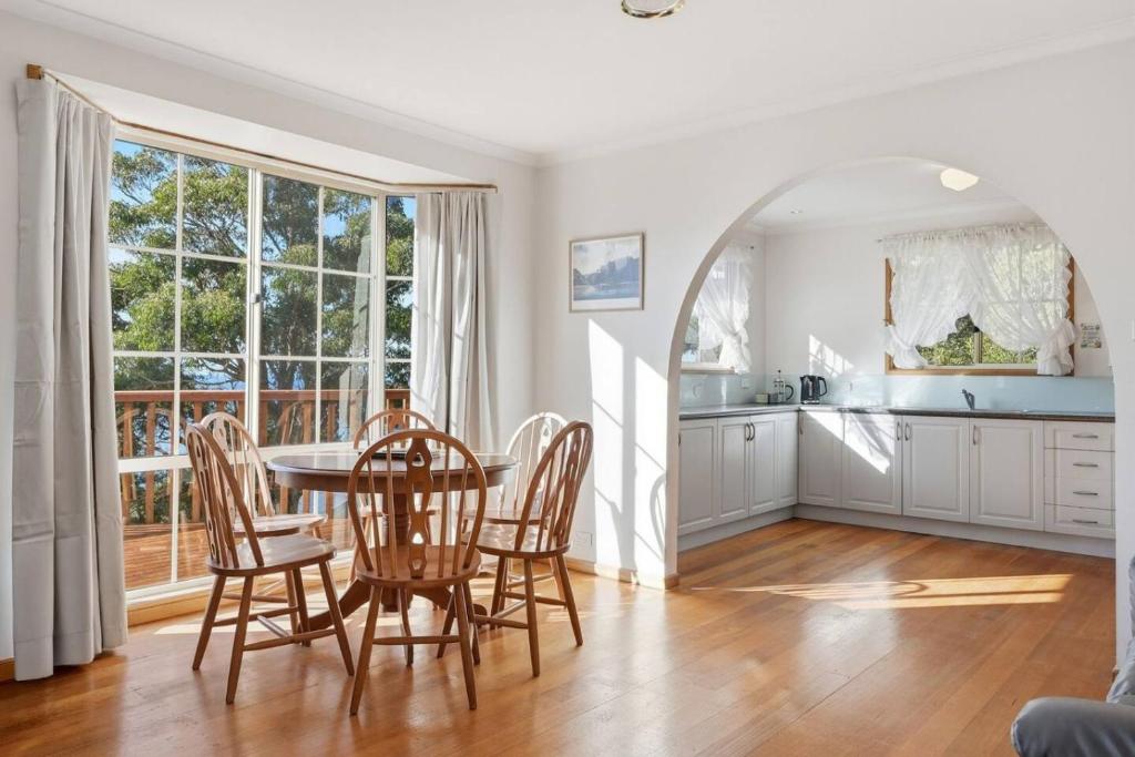 a kitchen and dining room with a table and chairs at Eaglehawk Neck Getaway in Eaglehawk Neck