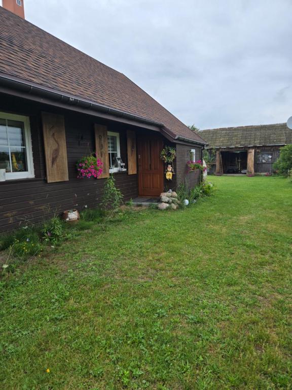 a house with a yard in front of it at Siedlisko Magnolia in Wólka Sulejowska
