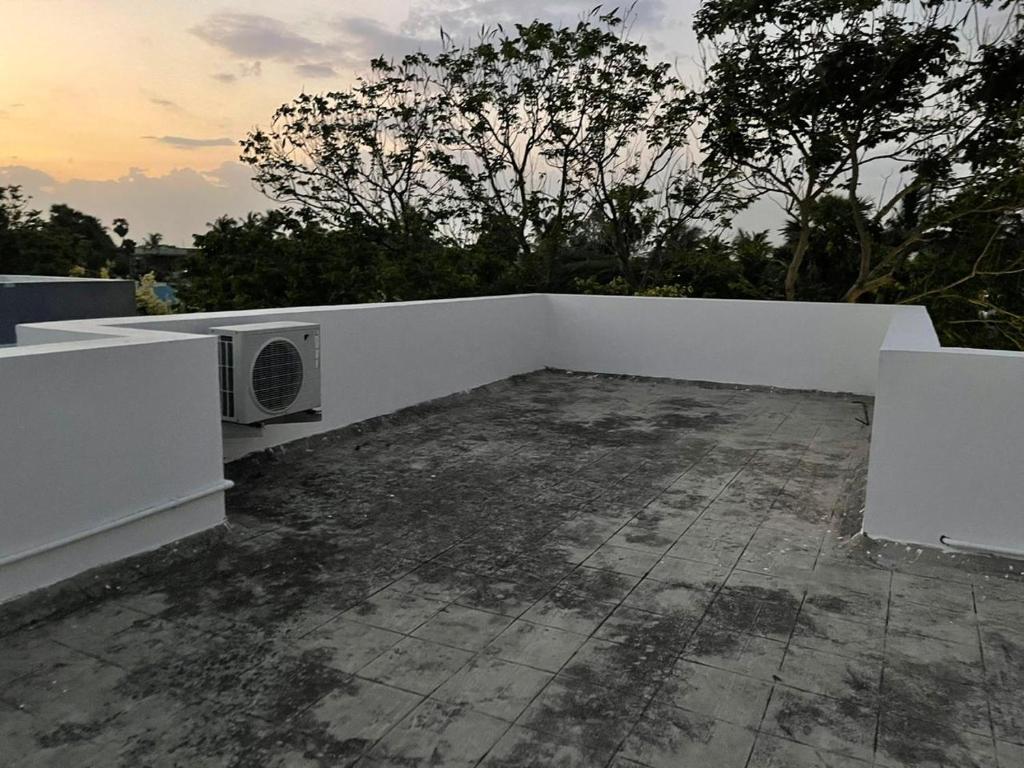 a white wall on top of a roof at Blue Breeze Villa in Mahabalipuram