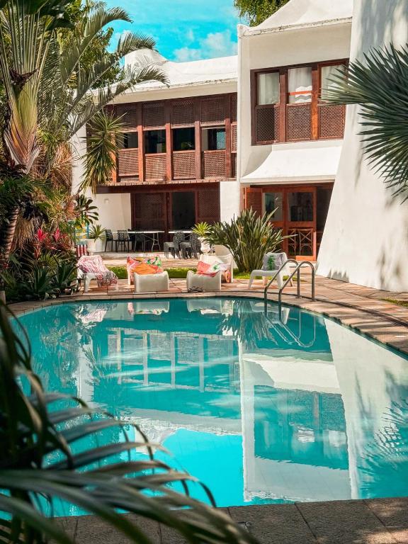 a swimming pool in front of a house at Les Jardins de Rio in Rio de Janeiro