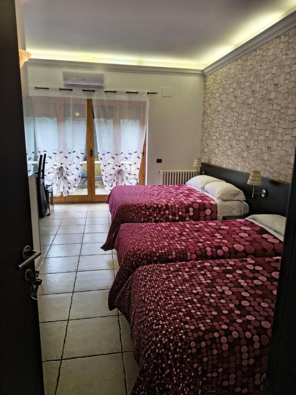 a bedroom with two beds and a window at Guest House Park in Valmontone