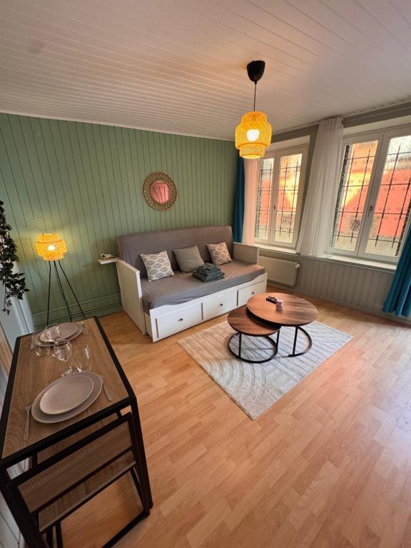 a living room with a couch and a table at Écrin de barr in Barr