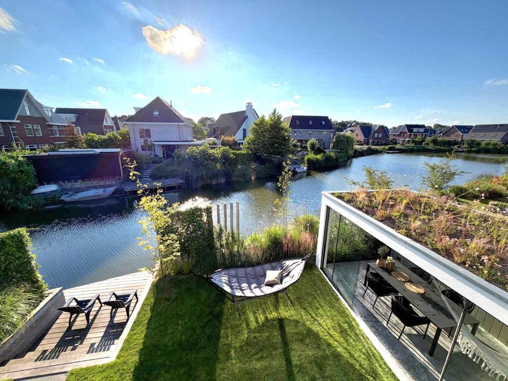 a balcony with chairs and a view of a river at Waterfront in Alkmaar