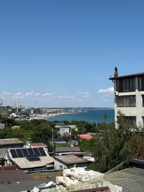 a view of a city with buildings and the ocean at Морской Двор in Chornomorsk