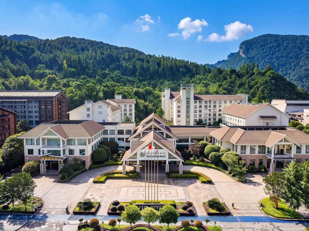 an aerial view of a town with mountains in the background at Pullman Zhangjiajie Hotel in Zhangjiajie