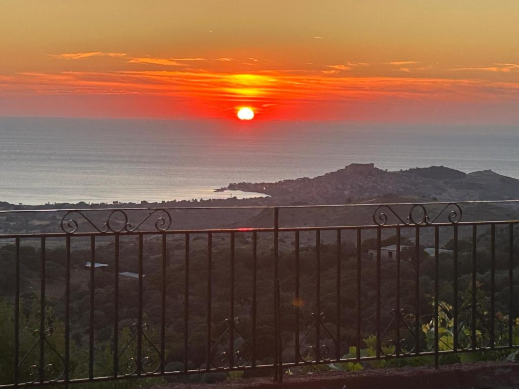 a sunset over the ocean from a balcony at Petrino view at vafios in Vafiós