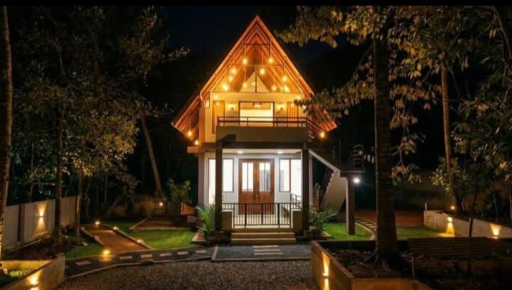 a home with a lit up house at night at Coffee Cabanas in Matale
