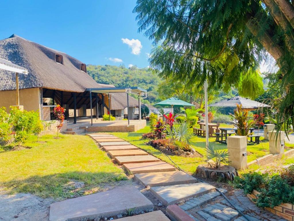 a house with a pathway leading to a yard at Siyaya’s Guest Palace in Jozini